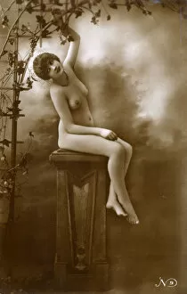 Jun18 Collection: French Pin-up girl - seated on a plinth beneath a vine