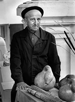 Beret Collection: Frenchman with large gourd in a market in Montaigu-de-Quercy