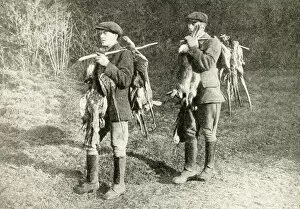 Two gamekeepers carrying pheasants and hares