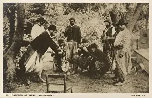 Gauchos Prints: Gauchos eating a meal in the open air - Argentina