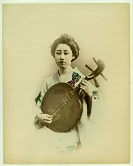 Japanese Prints Collection: Geisha playing musical instrument