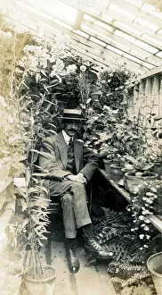 Boater Prints: Gentleman Gardener seated proudly in small home greenhouse