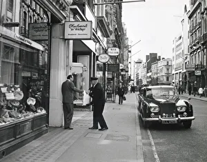 Expensive Gallery: A gentleman hands over his heavy bag of expensive French chocolates to his chauffeur