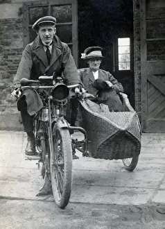 Gentleman & lady on a 1910 Triumph motorcycle & sidecar