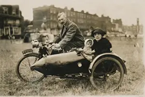 Disc Prints: Gentleman, lady & baby pose on unknown motorcycle