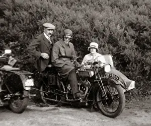Registration Prints: Gentlemen & lady on vintage motorcycle combination at roadsi