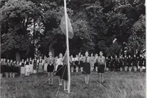 German boy scouts saluting Guide flag at camp