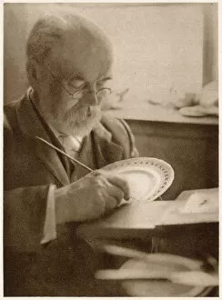 The gilder at work: gilding the edge of the plates. Date: 1913