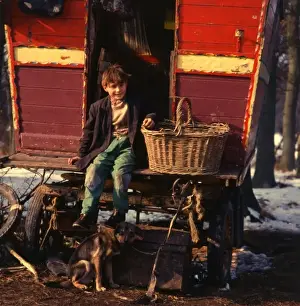 Gipsy boy sitting on the back step of his caravan