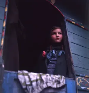 Gipsy girl looking out of the back of her caravan