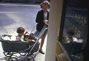 1950s Childhood Gallery: Girl with baby in pram, Cornwall