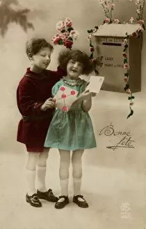 Girl and boy posting a letter