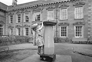 Girl climbing on a sundial outside Tulle House Museum Girl climbing on a sundial outside Tulle House Museum