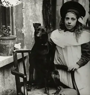 Girl with dog outside a house