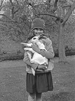 Woolly Prints: Girl holding rabbit in a garden