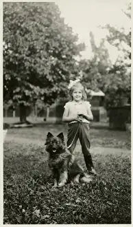 Girl in a park with her dog on a lead
