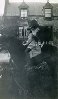Girl with pet dog on horseback, 1920s