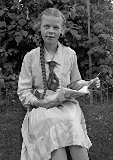 Plaited Prints: Girl sitting in garden with magazine