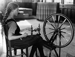 Images Dated 30th August 2011: Girl at a Spinning Wheel
