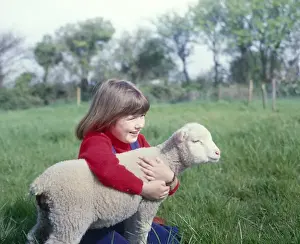 Girl with a spring lamb, West Country