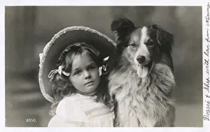 Girl in straw hat with dog