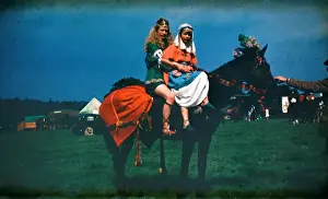 Plaited Prints: Two girls at a fair in medieval costume on horseback