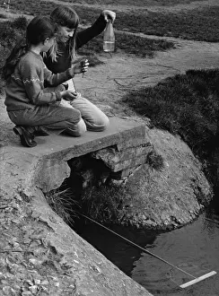 Crouching Prints: Two girls fishing in a stream