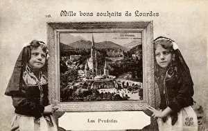 Lourdes Prints: Two girls hold a picture of Lourdes, Pyrenees, France