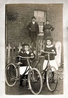 Bicycles Prints: Two girls with their new bicycles and proud parents
