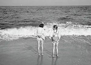 Images Dated 7th March 2017: Two girls playing on the beach in America