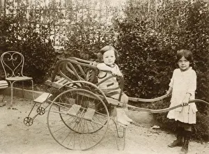 Rests Prints: Two girls playing with a push cart