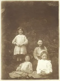 Four girls smiling in a garden