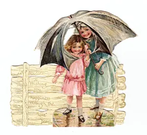 Two girls with umbrella on a cutout New Year card