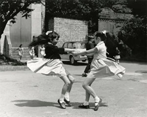 Images Dated 23rd July 2018: TWO GIRLS WHIRLING ROUND