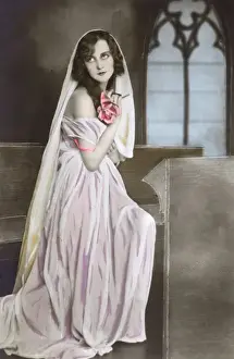 Glamorous French beauty in pious pose