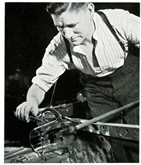 Glassware Collection: Glass blower fixing a handle on a jug
