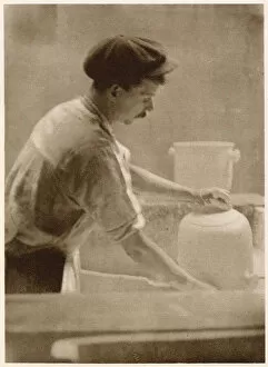 Clay Gallery: Glazing ware: a dipper at work in the dipping room. Date: 1913