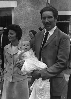 Images Dated 20th June 2011: Godfather holding baby at a christening