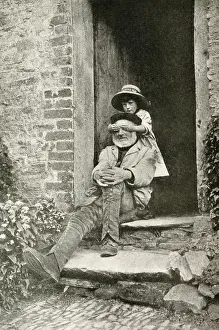 Doorstep Prints: Grandfather and granddaughter in a doorway, England