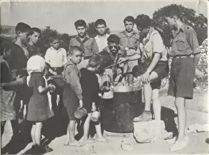 Greek boy scouts supplying water to children