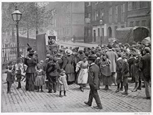 Judy Gallery: A group of amused London children gather round to watch a traditional Punch and Judy