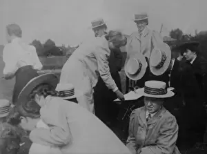 Bpeosa Prints: Group checking a score or a map