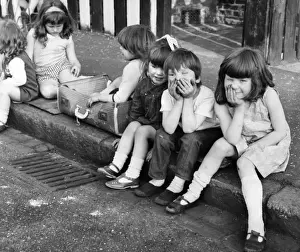 Drain Prints: Group of children sittiing on kerb, Balham, SW London