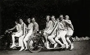 Registration Prints: Group of fun-loving fashionable people on two vintage motorc