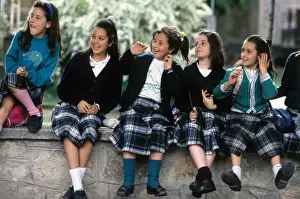 Happiness Prints: A group of happy schoolgirls wearing Spanish tartan skirts