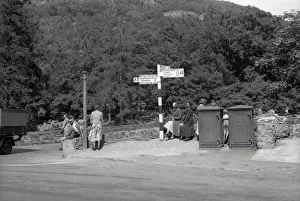Signpost Prints: Group of Holidaymakers waiting for their coach, North Wales