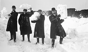 Group of men holding snow
