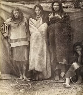 Group of Native Americans, three standing, one seated on the