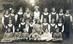 Group of schoolchildren with teacher, nurse and cat