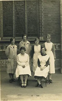 Aprons Gallery: Group of six women, wearing aprons or overalls. They look as if they are staff at a